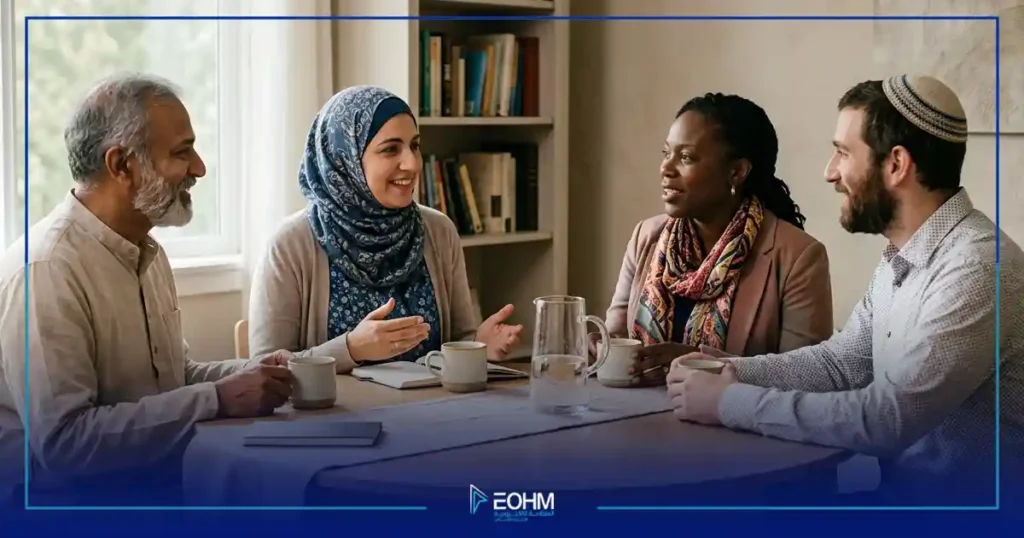 أشخاص من ديانات مختلفة يتبادلون الحديث في أجواء هادئة تعكس التعايش واحترام الآخر