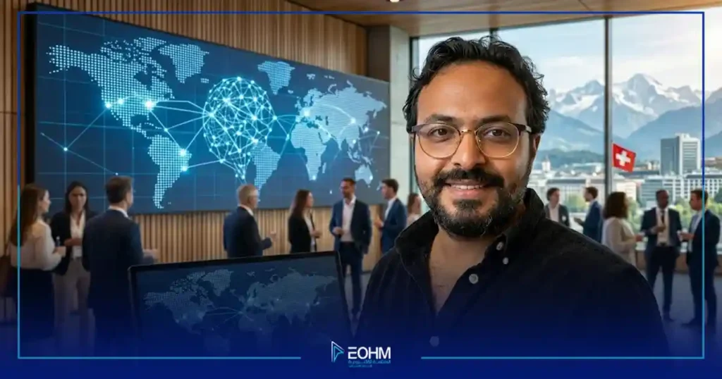 بورتريه احترافي مبتسم للصحفي اليمني فراس شمسان بنظارات وقميص أسود، يظهر في قاعة مؤتمرات منتدى حوكمة الإنترنت السويسري Swiss IGF 2026 في جنيف، وبخلفية شاشة LED كبيرة تعرض رسومًا بيانية لشبكات عالمية ومناظر طبيعية لجبال الألب السويسرية وعلم سويسرا.